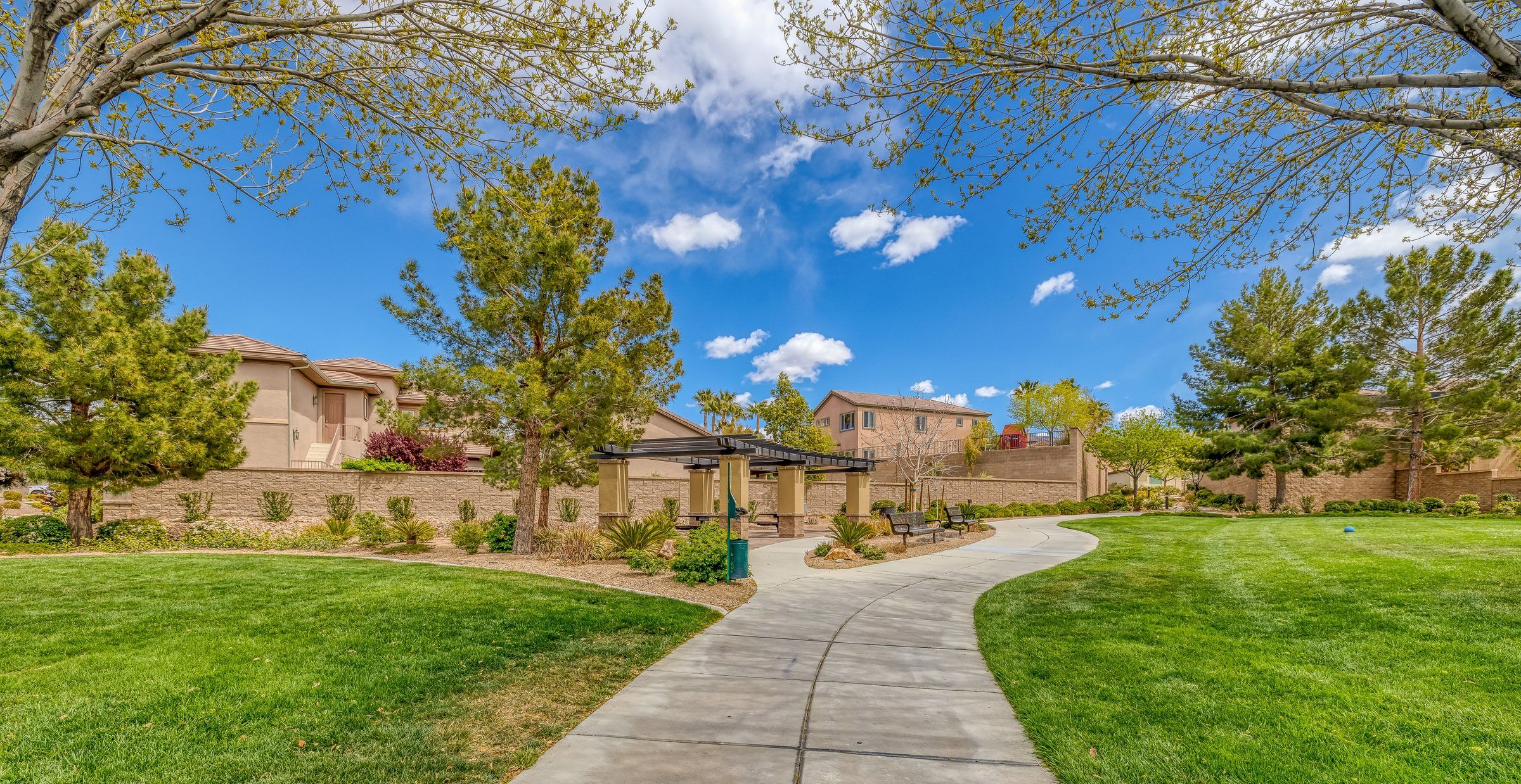 Landscaped walking path and green space beside Anthem Highlands homes